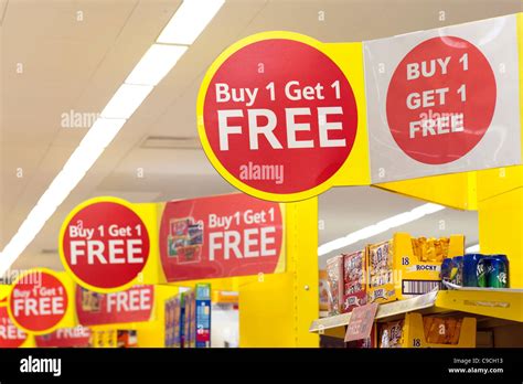 Buy one get one free and special offers signs at Tesco Extra Stock Photo - Alamy