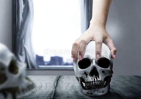 Hand Holding A Human Skull On The Wooden Table Stock Photo Image Of