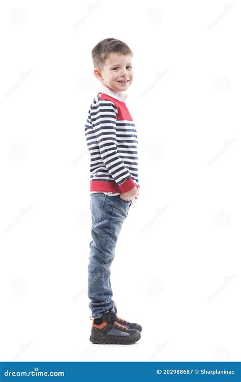 Side View Of Cute Happy Young Boy Smiling And Looking At Camera With