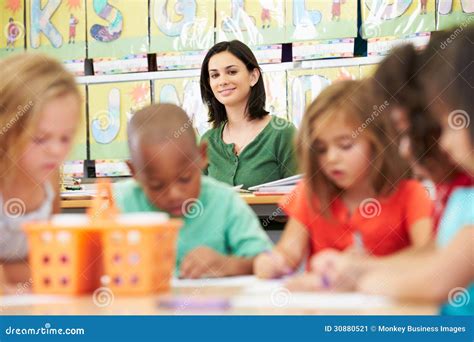 Group Of Elementary Age Children In Art Class With Teacher Stock Image