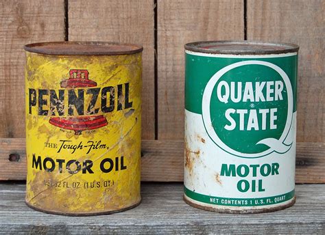 This Set Of Two Vintage Motor Oil Cans Includes A Cardboard Pennzoil
