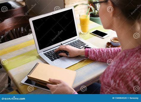 Young Freelancer With Laptop Working And Notebook In Cafe Stock Photo