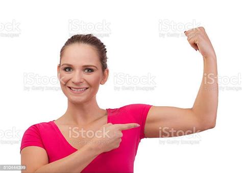 Closeup Picture Of Sporty Smiling Woman Flexing Her Biceps Stock Photo