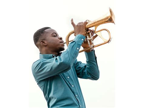 African Black Man Playing Jazz Music On Trumpet Free Photo Cariblens