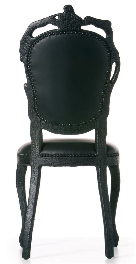 The classy smoking chair also comes with an ottoman made from the same type of wood and leather for a true relaxing spot for smoking your favorite cigars. Smoke Chair Padded chair - Wod & leather Black by Moooi
