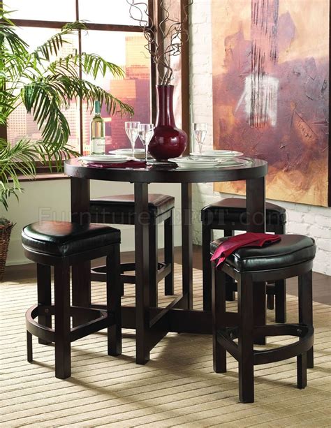 The table rests on a pedestal post and rises on splayed legs. Cherry Finish 5Pc Modern Counter Height Dining Set w/Round Top