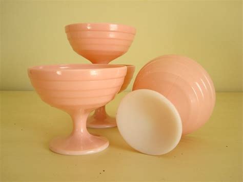 Three Pink Goblets Sitting Next To Each Other On A Yellow Tableclothed