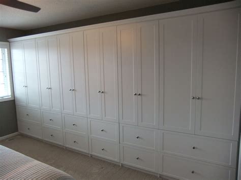 Office storage & organization : Wall to wall cabinets with drawers below, shelving behind ...