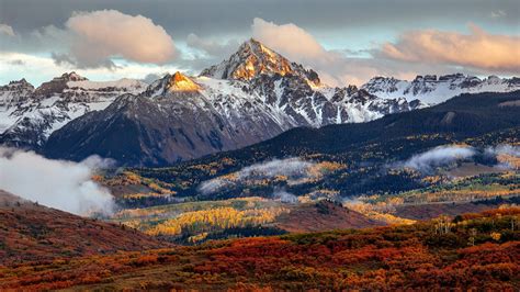 Landscape View Of White Covered Mountains Under White Cloudy Sky And