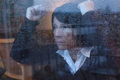 A Woman Looking Out The Window On A Rainy Day Stock Image Image Of