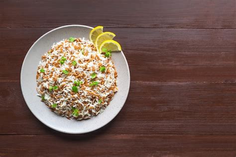 Premium Photo Turkish Rice Pilaf With Orzo In A Plate On A Wooden