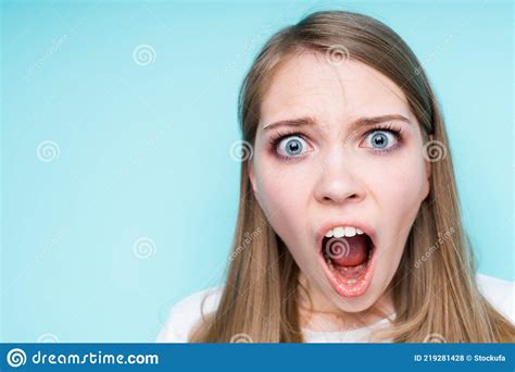 Close Up Photo Beautiful Girl Opens Her Mouth And Is Surprised By Raising Her Eyebrows Stock