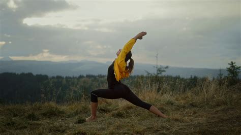 Side View Yoga Woman Doing Warrior Pose In Mountains Flexible Girl