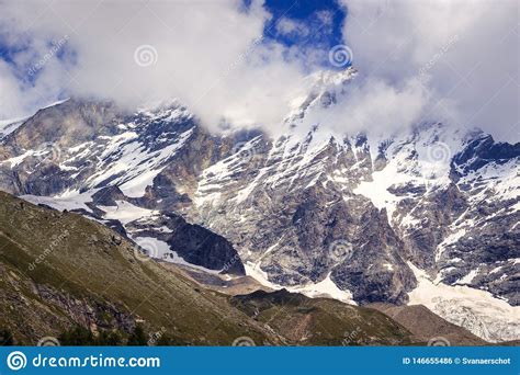 Snow Capped Mountain Peak In Clouds Stock Photo Image Of Scenic