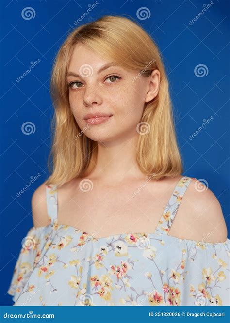 Closeup Front View Of An Adorable Blonde Young Woman With Blonde Hair Looking At Camera