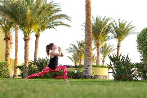 Slender Girl Does Yoga Exercises In The Early Morning At The Resort
