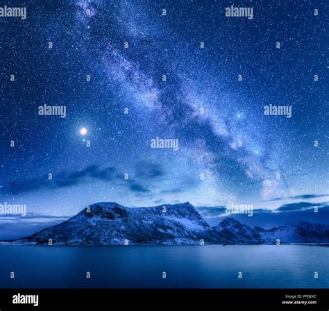 Bright Milky Way Over Snow Covered Mountains And Sea At Night In Winter