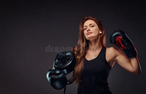 beautiful sportive female boxer in sportswear wearing boxing gloves shows muscles isolated on