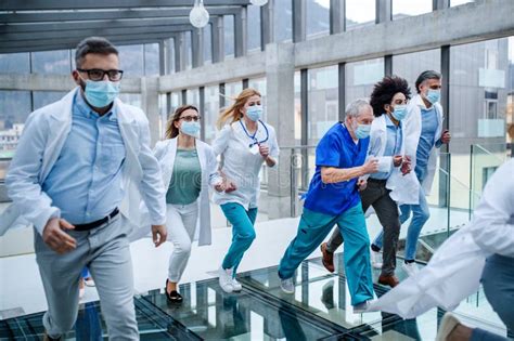Group Of Doctors Running In Corridor Of Hospital Emergency Concept Stock Image Image Of