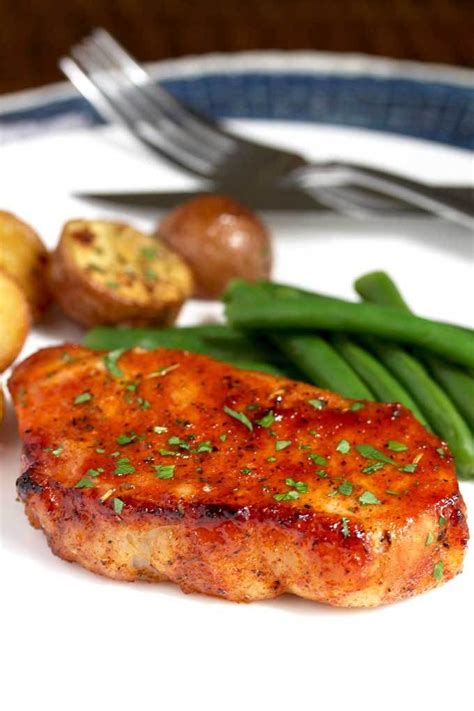 Find recipes for boneless pork chops, plus videos and reviews with helpful hints. An oven baked pork chop on a white plate with roasted potatoes and green beans. | Baked pork ...