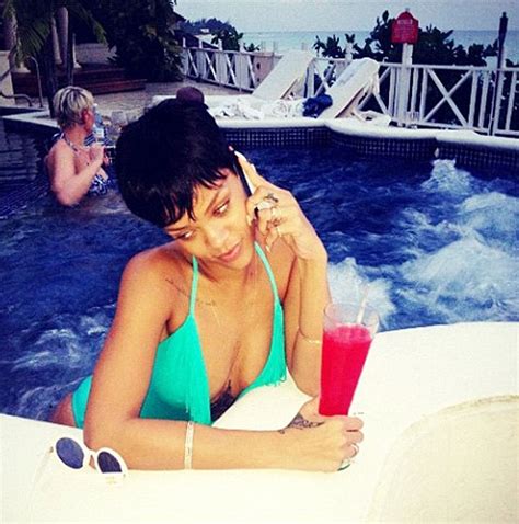 Rihanna Toasts The Holidays With A Cocktail In The Pool Daily Mail Online
