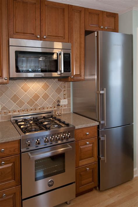 Those small cabinet door towel racks can be flipped around so the rung is on the inside of the cabinet instead. Small Kitchen Remodel, Elmwood Park IL - Better Kitchens