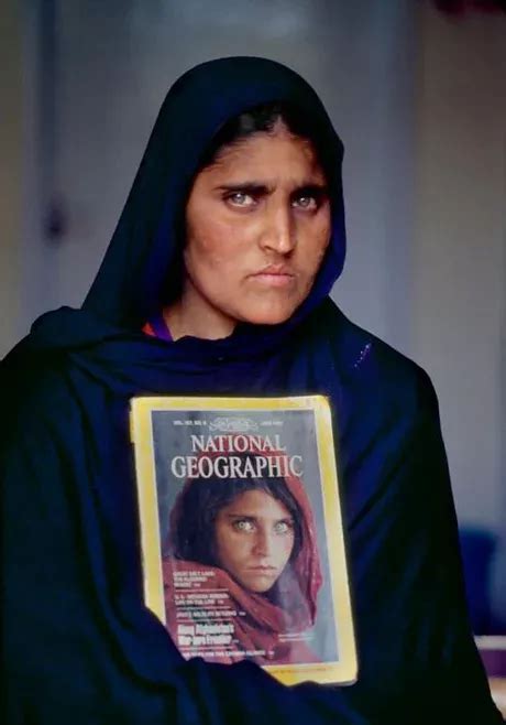 Sharbat Gula National Geographics The Afghan Girl In 2002 Holding The 1984 Issue With Her