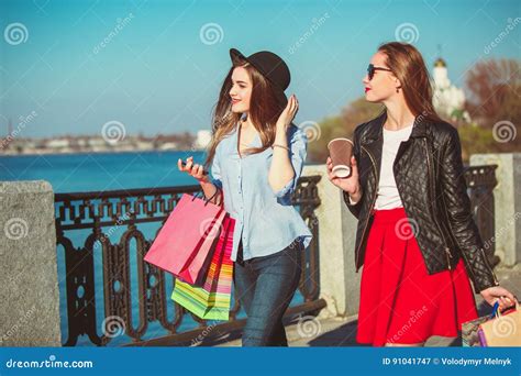 Two Girls Walking With Shopping On City Streets Stock Image Image Of