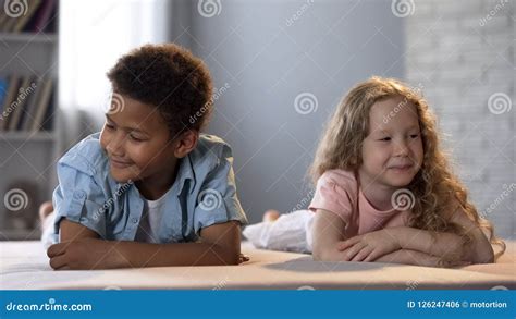 Little Boy And Girl Shyly Turn Away Each Other Smiling Childhood