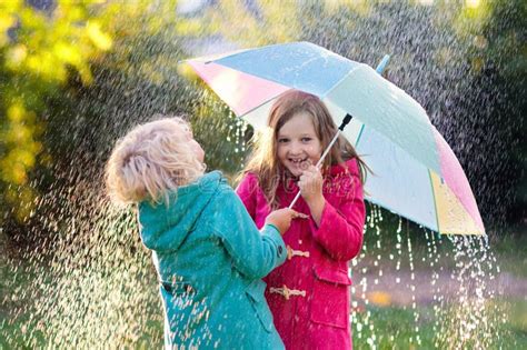 Kids With Umbrella Playing In Autumn Shower Rain Stock Photo Image Of