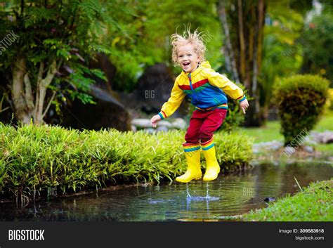 Child Playing Puddle Image And Photo Free Trial Bigstock