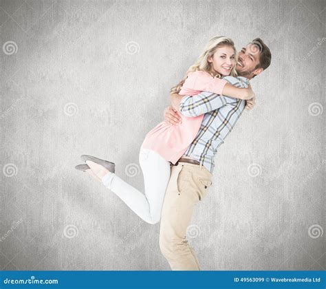 Composite Image Of Handsome Man Picking Up And Hugging His Girlfriend