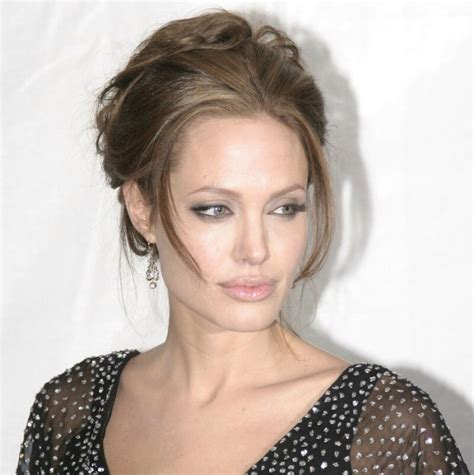 Angelina Jolies Hair Pulled Back And Styled Up With A Circular Based