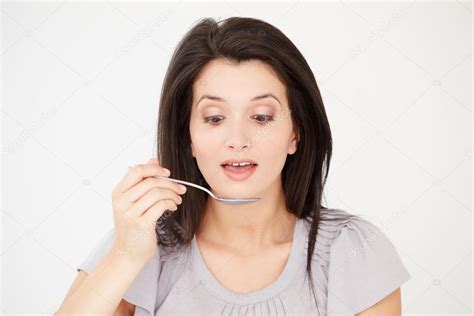 Woman Eating With Spoon Stock Photo By Monkeybusiness