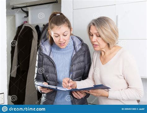 Mature Woman Answers Questions Of The Interviewer At Home Stock Photo
