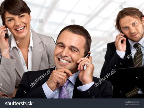Three Happy Business People Talking On Stock Photo