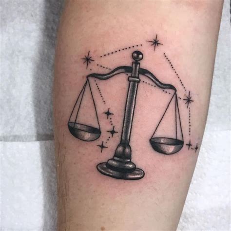 A Black And White Photo Of A Tattoo On The Leg Of A Person With An