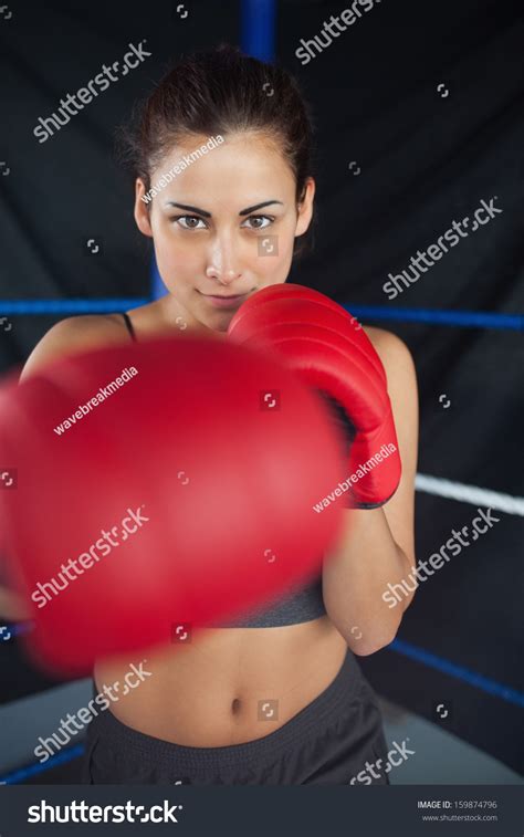 Portrait Of A Beautiful Young Woman In Red Boxing Gloves In The Ring