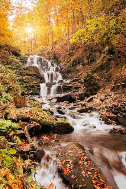Premium Photo Beautiful Waterfall With Trees Red Leaves Rocks And