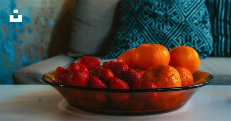 A Bowl Of Oranges And Strawberries On A Table Photo Free Plant Image