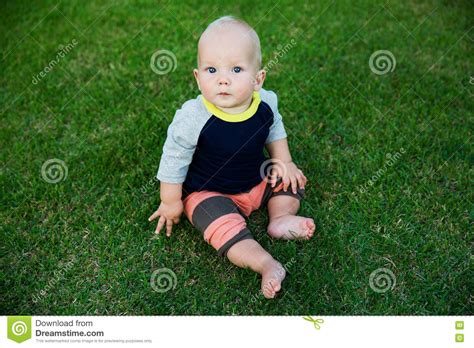 Happy Adorable Baby Boy Sitting On The Grass Stock Image Image Of