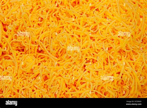 Grated Red Cheddar Cheese In Close Up Stock Photo Alamy