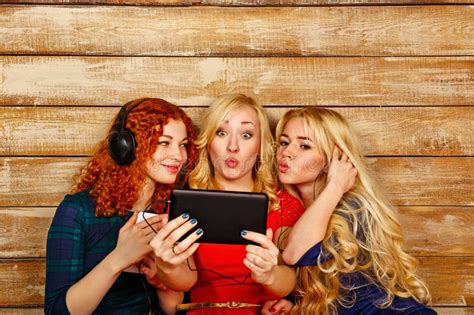 Sisters Make Fun Selfie Listening To Music On Headphones Stock Image