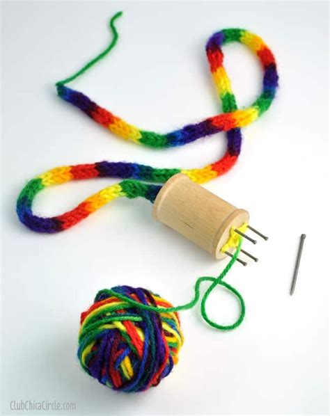 The Yarn Is Being Used To Make A Colorful Ball Of Yarn With A Wooden Spool