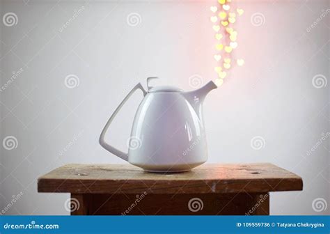 White Teapot And Heart Shaped Bokeh Over It On White Background