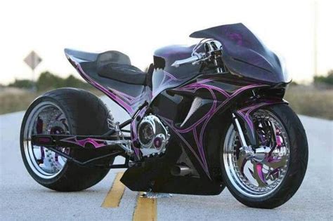 A Black And Purple Motorcycle Parked On The Street