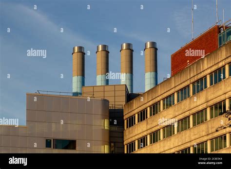 Four Industrial Chimneys On Top Of A Modern Building Stock Photo Alamy