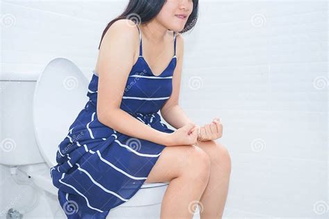 Woman Sitting On Toilet With Hands Fist Constipation Concept Stock