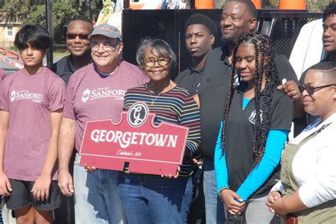 Community Comes Together To Install 65 Sign Toppers In Georgetown