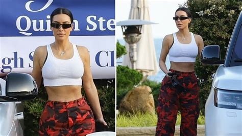kim kardashian flaunts very tiny waist in a sports bra and red camo pants as she treats north